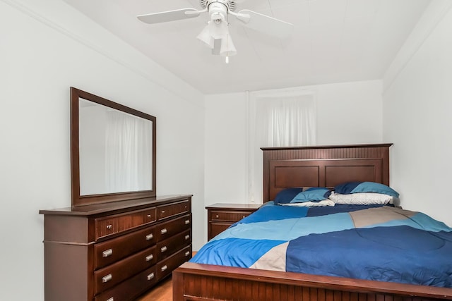 bedroom with ceiling fan and ornamental molding