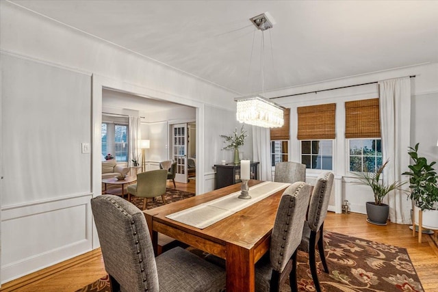 dining room with a chandelier and light wood-type flooring