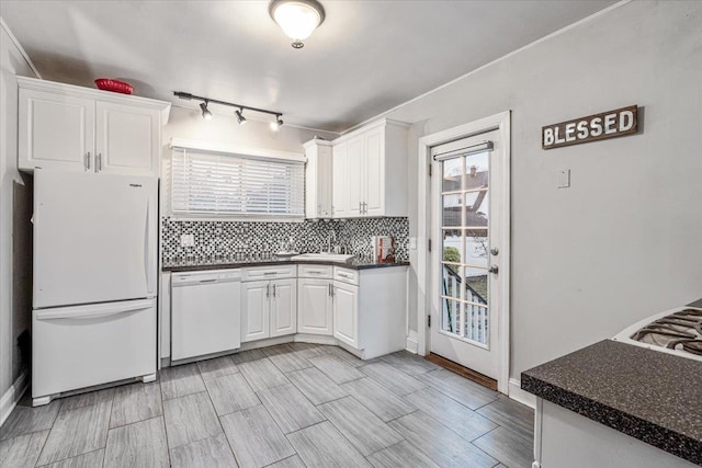 kitchen featuring white cabinetry, white appliances, and decorative backsplash