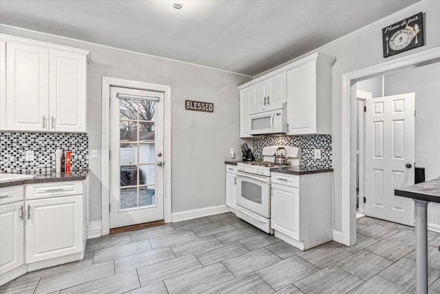 kitchen featuring tasteful backsplash, sink, white cabinets, and white appliances