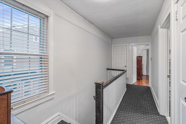 hallway with carpet floors