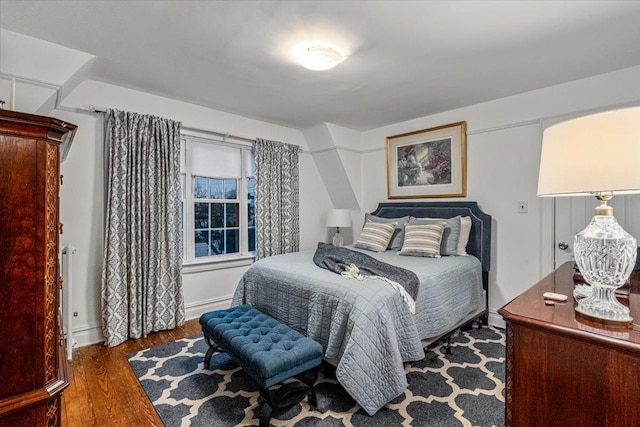 bedroom with dark hardwood / wood-style floors