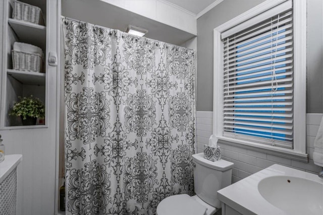 bathroom with vanity, ornamental molding, tile walls, and toilet