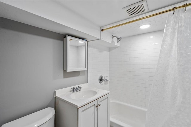 full bathroom featuring vanity, toilet, and shower / bath combo