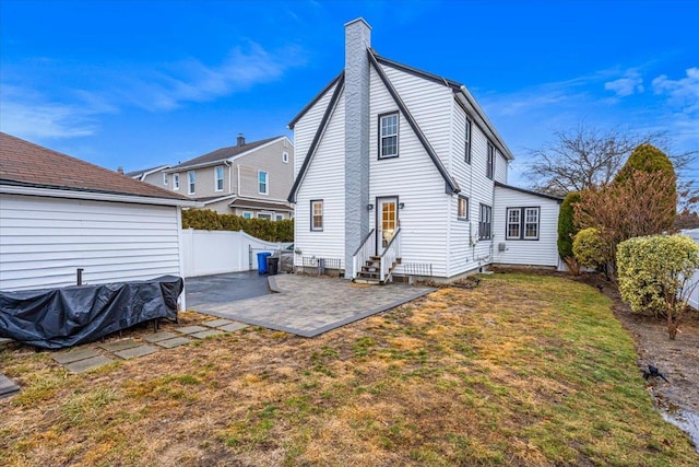 rear view of house featuring a patio and a yard