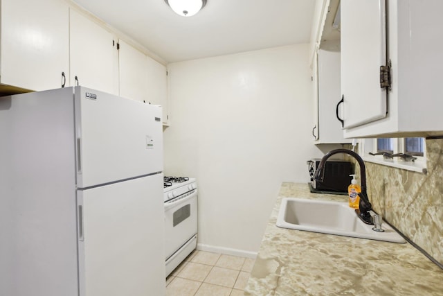 kitchen featuring sink, white appliances, white cabinetry, and light tile patterned floors