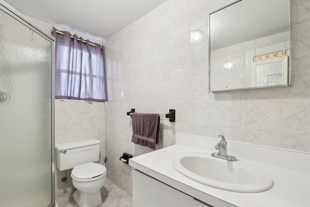 bathroom with vanity, toilet, tile walls, and an enclosed shower