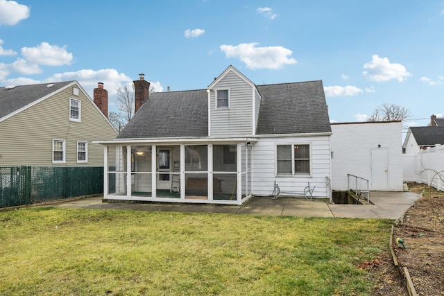 rear view of house featuring a patio area, a sunroom, and a lawn