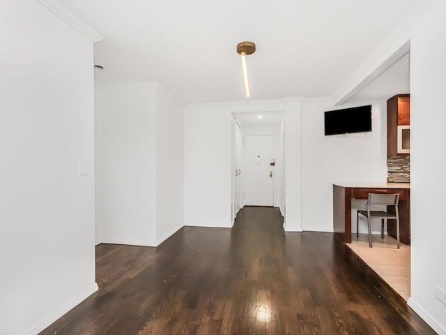 interior space featuring ornamental molding and dark hardwood / wood-style floors