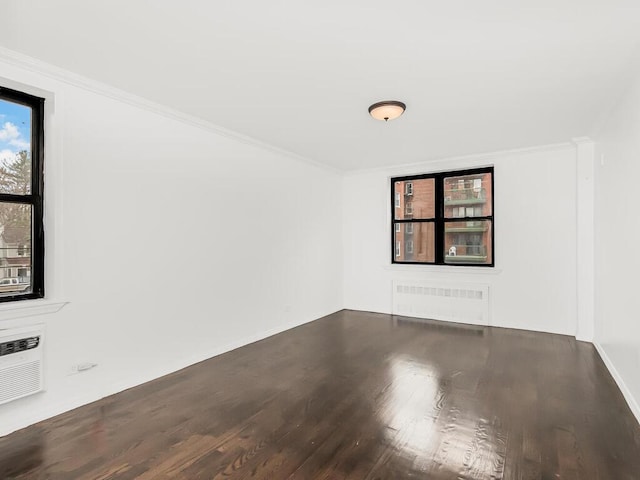 unfurnished room with hardwood / wood-style flooring and crown molding