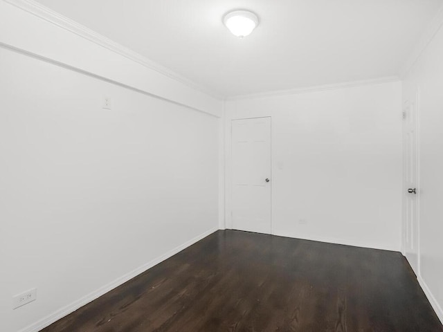 spare room featuring wood-type flooring and ornamental molding