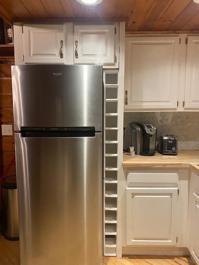1139 State Route 17b, Mongaup Valley, NY 12762 - kitchen with freestanding refrigerator, wooden ceiling, light countertops, white cabinetry, and tasteful backsplash