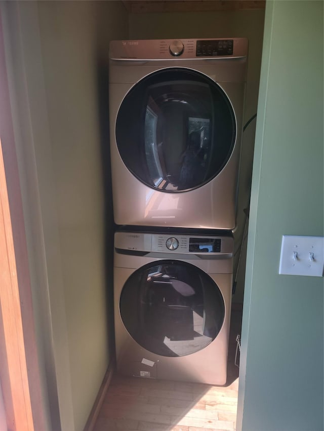 1139 State Route 17b, Mongaup Valley, NY 12762 - laundry area featuring stacked washer and clothes dryer and wood finished floors