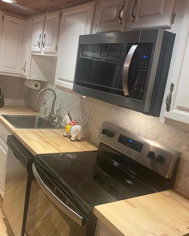 1139 State Route 17b, Mongaup Valley, NY 12762 - kitchen with appliances with stainless steel finishes, tasteful backsplash, white cabinets, and wooden counters