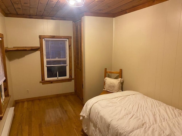 1139 State Route 17b, Mongaup Valley, NY 12762 - bedroom with hardwood / wood-style flooring, wood ceiling, and a baseboard radiator
