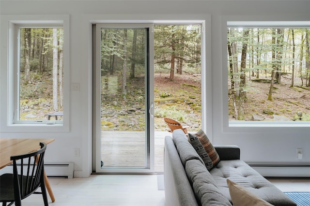 doorway to outside featuring a baseboard heating unit