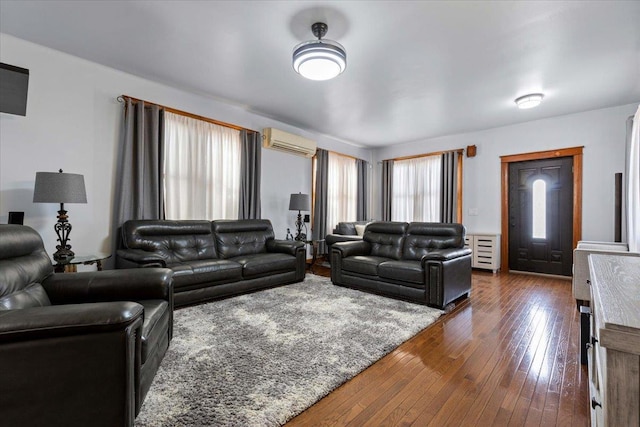 living room featuring a wall mounted AC and dark hardwood / wood-style flooring