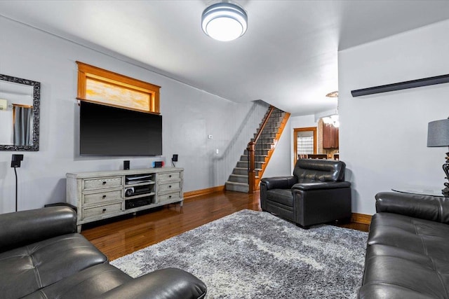 living room with dark hardwood / wood-style flooring, a notable chandelier, and a wealth of natural light