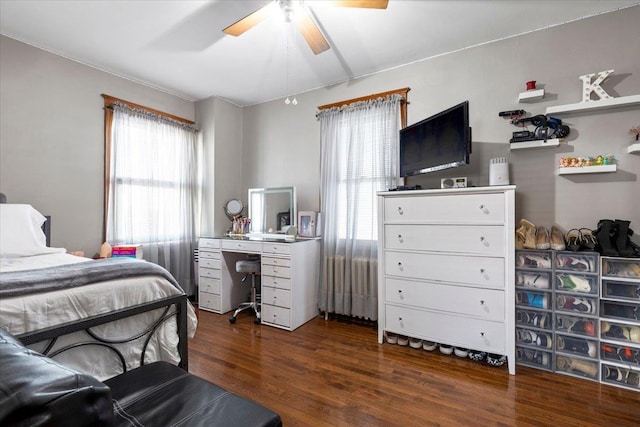 bedroom featuring multiple windows, dark wood-type flooring, and ceiling fan