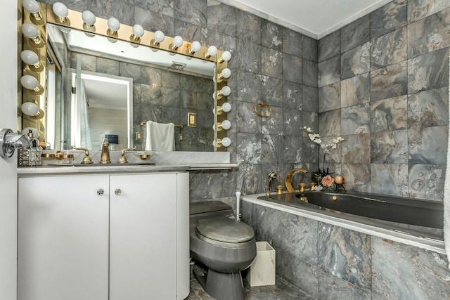 bathroom featuring tiled bath, toilet, tile walls, and vanity