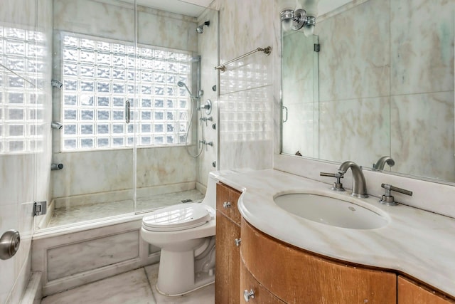 bathroom with toilet, a shower with door, tile patterned floors, and vanity