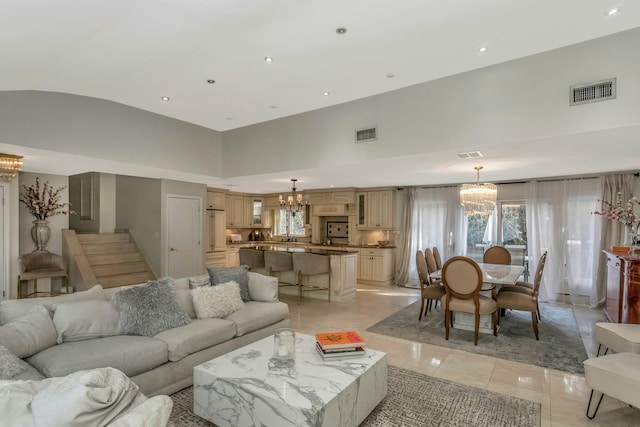 tiled living room featuring vaulted ceiling and a notable chandelier