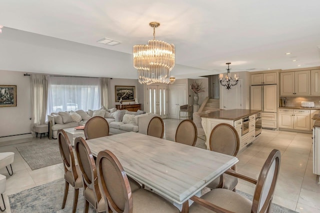 dining space featuring light tile patterned floors and a notable chandelier