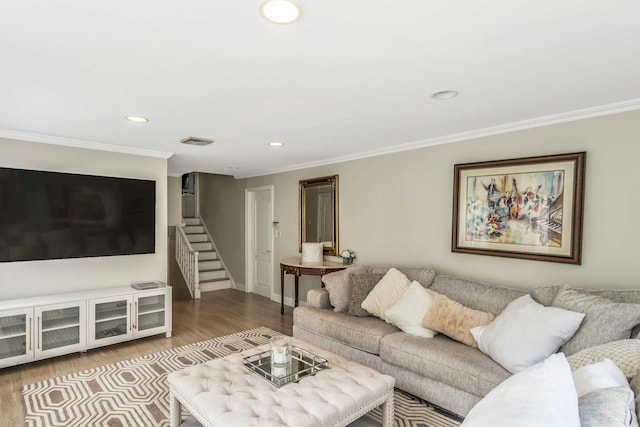 living room featuring light hardwood / wood-style flooring and crown molding