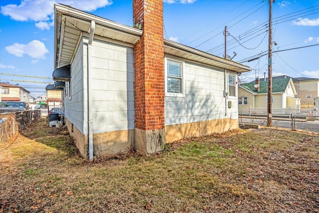 view of property exterior with a yard