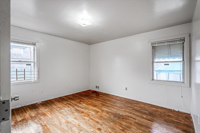 spare room with wood-type flooring