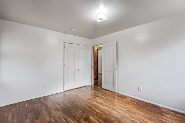 unfurnished bedroom with a closet and wood-type flooring