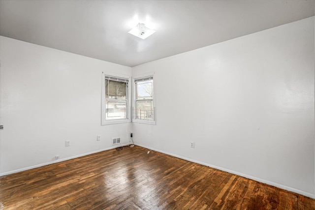 empty room featuring dark wood-type flooring