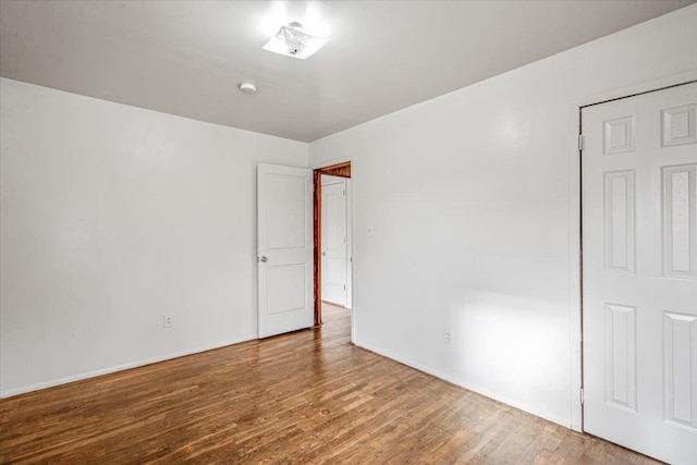 spare room featuring wood-type flooring