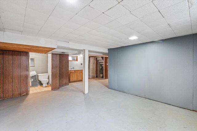 basement with sink and a drop ceiling