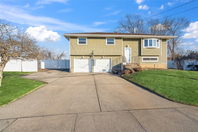 split foyer home with a front yard and a garage