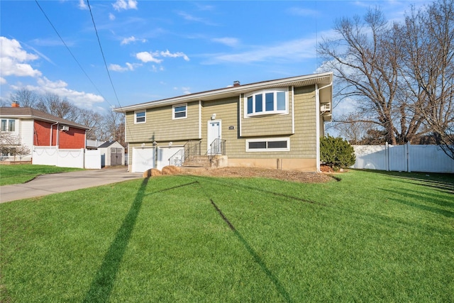 split foyer home featuring a front lawn and a garage