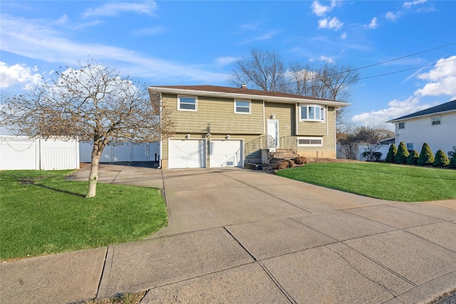 view of front of property featuring a garage and a front lawn