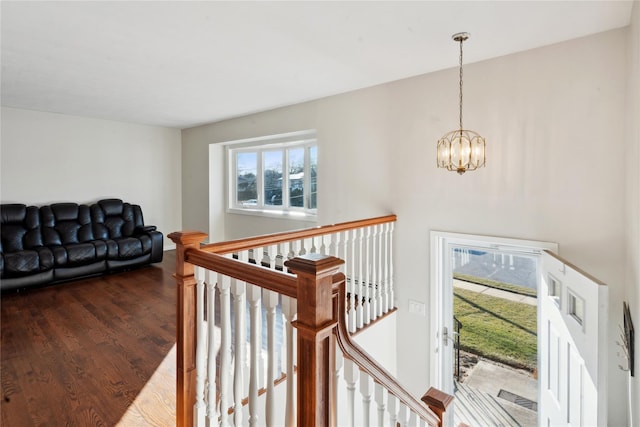 interior space featuring wood-type flooring, a notable chandelier, and a wealth of natural light