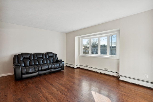 living area with dark wood-type flooring and a baseboard heating unit