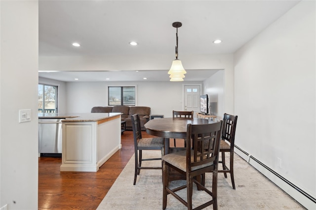 dining space featuring dark hardwood / wood-style flooring and a baseboard radiator