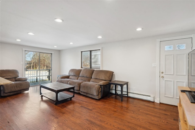 living room with baseboard heating and dark hardwood / wood-style floors