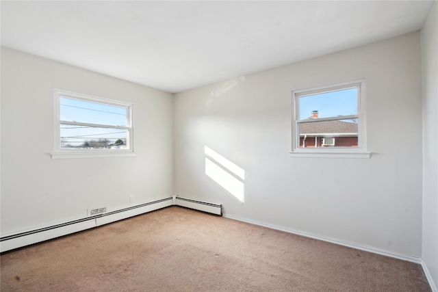 unfurnished room with light carpet, a healthy amount of sunlight, and a baseboard radiator