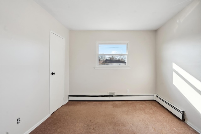 empty room with light colored carpet and a baseboard heating unit