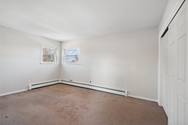 unfurnished bedroom with baseboard heating, a closet, and carpet flooring