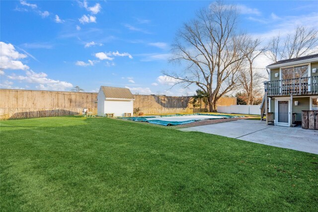 view of yard featuring a storage shed, a patio area, and a covered pool