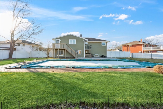 view of swimming pool with a lawn and a diving board