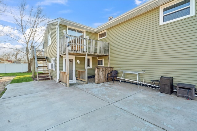 rear view of property featuring a patio area and a balcony