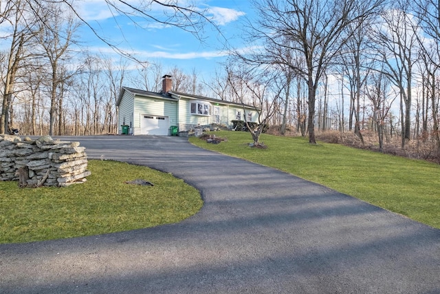 view of front of house featuring a garage and a front lawn