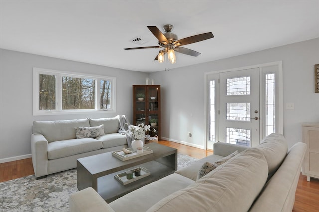 living room featuring ceiling fan and light wood-type flooring