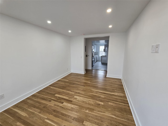 unfurnished room with dark hardwood / wood-style flooring